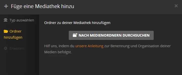 Dunkles UI-Fenster zum Hinzufügen von Ordnern zur Mediathek; grauer Button 'NACH MEDIENDENORDNEN DURCHSUCHEN'.
